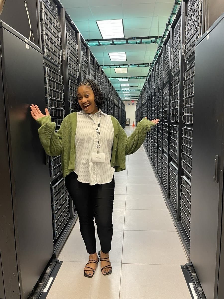 Ashley between supercomputer racks